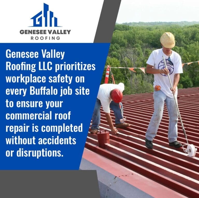 Two roofers in hard hats working on a red metal commercial roof